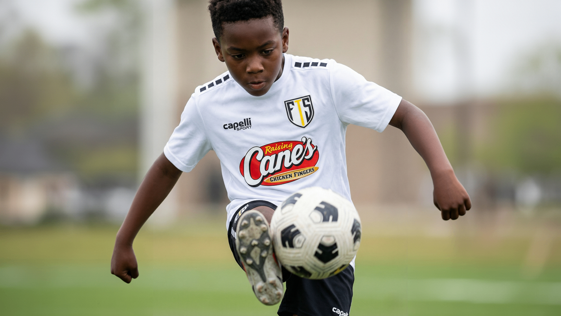 Young FTS camper controlling the ball mid-air during training